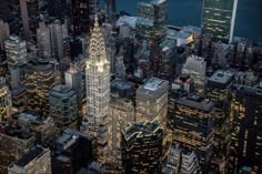 an aerial view of new york city at night with the empire building in the foreground