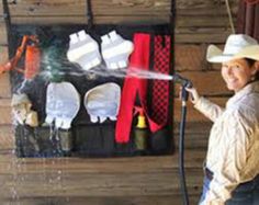 a woman wearing a cowboy hat sprays water on her clothing and other items in the background