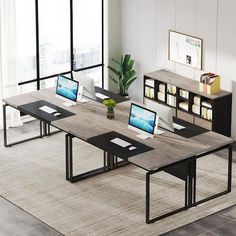 an office desk with multiple computers on it