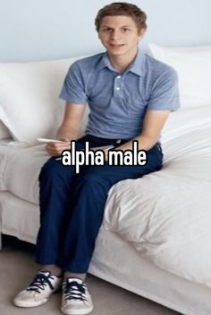 a young man sitting on top of a white couch next to a bed with the caption, alpha male