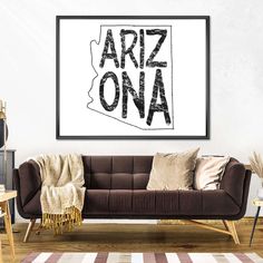 a living room with a couch, table and rug in front of the wall that says artz ona