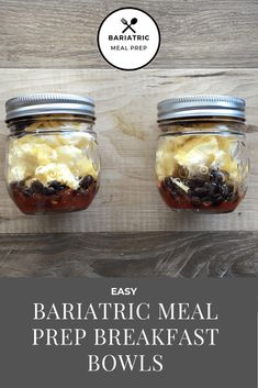 two jars filled with food sitting on top of a wooden table