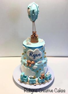 a blue and white baby shower cake with a hot air balloon on top