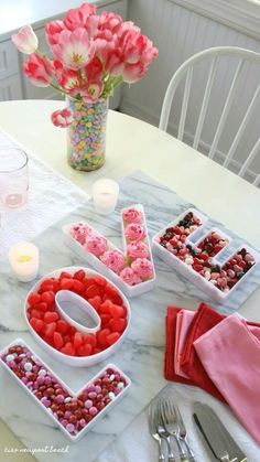 valentine's day table setting with candy and flowers