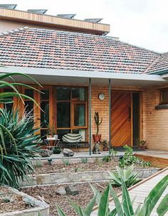 a house that has some plants in front of it