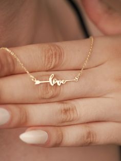 This Love Arrow 14K Gold Necklace promises to be a captivating symbol of your enduring love and passion. Imagine wearing this exquisite piece, a constant reminder of the powerful connection you share with your special someone. Crafted with meticulous attention to detail, this necklace will become a cherished treasure, adding a touch of elegance and romance to any ensemble. The delicate arrow, representing the unwavering strength of Cupid's love, will make this necklace a truly meaningful and ins Meaningful Jewelry For Valentine's Day Anniversary, Valentine's Day Jewelry With Adjustable Chain For Anniversary, Adjustable Chain Jewelry For Anniversary And Valentine's Day, Valentine's Day Meaningful Jewelry For Anniversary, Meaningful Valentine's Day Anniversary Jewelry, Valentine's Day Nameplate Jewelry With Hallmark, Meaningful Rose Gold Necklace For Valentine's Day, Symbolic Yellow Gold Jewelry For Valentine's Day, Meaningful Jewelry For Anniversary On Valentine's Day