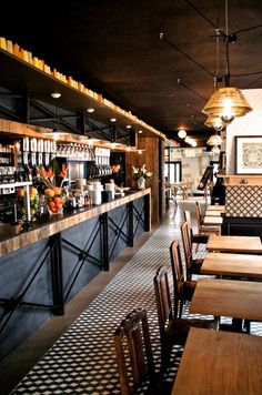 an empty restaurant with wooden tables and chairs