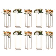 six gold metal plant stands with flowers on each side and four smaller ones in the middle