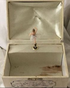 a small figurine in a white box