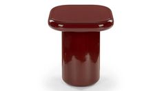 a red stool sitting on top of a white floor