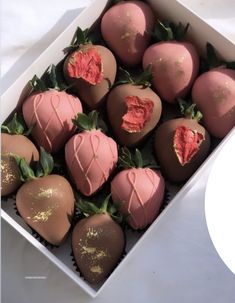 a box filled with chocolate covered strawberries on top of a table