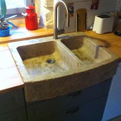 a kitchen sink that has been made out of concrete and is in the middle of a counter top