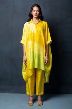 Lemon and light yellow draped shirt tunic with geometric abstract print. Paired with printed pant.
Component: 2
Pattern: Printed
Type Of Work: Abstract,Geometric
Neckline: Shirt Collar
Sleeve Type: Long
Fabric: Dupion Silk
Color: Yellow
Other Details: 
Abstract print
Occasion: Work - Aza Fashions Asymmetric Kurti Designs, Collared Kurti, Printed Cord Set, Kaftan Shirt, Draped Shirt, Kaftan Kurta, Asymmetric Tunic, African Fabric Dress, Abstract Shirt