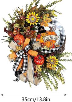 a fall wreath with sunflowers, pumpkins and other autumn decorations on it