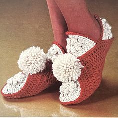 a woman's feet wearing red and white crocheted slippers