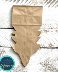 a piece of brown paper sitting on top of a wooden table