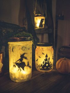 three mason jars with halloween images on them