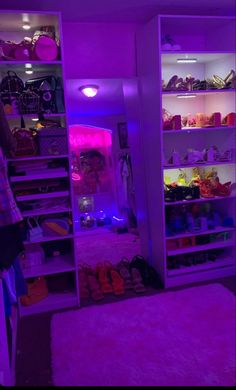 a room with purple lighting and lots of shoes on the shelves in front of it