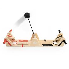 a wooden toy boat with a black ball on it's handle and two red handles