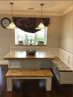 a wooden bench sitting under a window in a kitchen