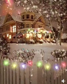 a house with christmas lights in the front yard and snow on the ground behind it