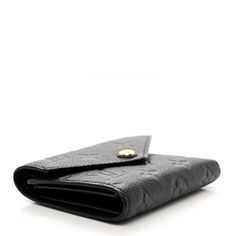 This is an authentic LOUIS VUITTON Empreinte Victorine Wallet in Black. This stylish wallet is crafted of Louis Vuitton monogram embossed calfskin leather in black. This wallet opens with a polished brass snap to a matching black leather interior with card slots, patch pockets, a bill compartment, and a zipper pocket. Black Louis Vuitton, Louis Vuitton Empreinte, Louis Vuitton Wallet, Leather Interior, Polished Brass, Authentic Louis Vuitton, Louis Vuitton Monogram, Patch Pocket, Card Slots