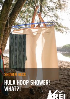 two people hanging clothes on a rope in front of a tree with the words shower hack hula hoop shower what?