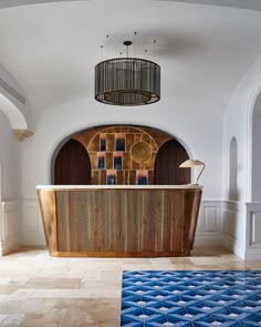 a large wooden bathtub sitting in the middle of a room next to a chandelier