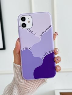 a woman is holding up her phone case