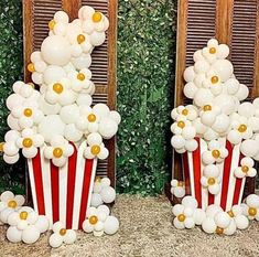 two red and white popcorn boxes filled with balloons