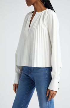 Accordion pleats fan out from the neckline, flaring the silhouette of this popover top framed with raglan sleeves with tailored-touch two-button cuffs. 22 1/2" length (size 2) Split neck Long sleeves with two-button cuffs 96% cotton, 4% elastane Dry clean Imported Designer Clothing Pleated Tops For Daywear In Fall, Classic Pleated Tops For Fall, Pintuck Tops For Daywear In Fall, Classic Formal Tops With Gathered Sleeves, Fall Classic Pleated Tops, Fall Tops With Pintucks For Daywear, Fall Daywear Tops With Pintucks, Classic Pleated Office Tops, Classic Fitted Tops With Pleated Sleeves