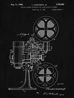 a black and white drawing of an old movie projector with the film reel attached to it