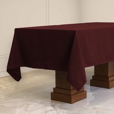 a table with a red cloth on it in a room next to a white wall