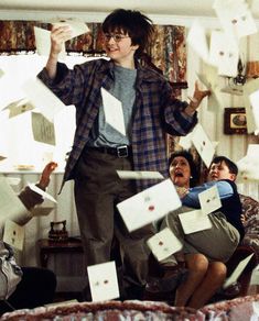 a man is surrounded by papers flying in the air