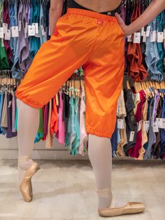 The MP5004 orange warm-up dance trash bag pants are designed to provide optimal warmth to your leg muscles during or between dance classes or rehearsals, ensuring comfortable movement. Product Details Size Small: height up to 167 cm / 5'6 ft Size Medium: height from 168 cm to 185 cm / 5'7 to 6'2 ft Suitable for both women and men Crafted from a high-quality nylon to ensure maximum comfort and durability, making them perfect for frequent wear Elastic hems at the bottom, so you can adjust them to Trash Bag Pants, Stylish Overalls, Dance Warm Up, Lycra Shorts, Ballet Tights, Bag Pants, Man Crafts, Dance Classes, Nylon Pants