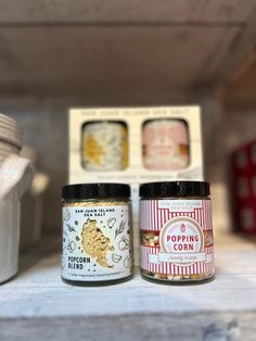 two jars of food sitting on top of a shelf