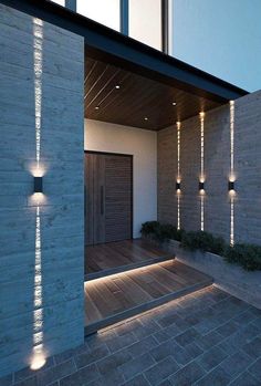 an outdoor area with some lights on the wall