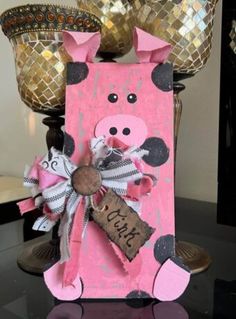 a pink and black cow decoration sitting on top of a table