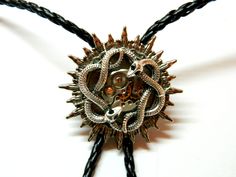 "Sun Steampunk Bolo Tie Snakes, silver or golden, with green emerald eyes, honeymoon surprise, bola fashion silver steam punk accessory clockwork, unique birthday gift mens jewelry. Black leatherette cord and moon metal pendants. Unique birthday gift, honeymoon surprise, wedding, Valentine's Day, Father's Day. Size of about 1 1/2\" / 4 cm diameter of the solar disk Length of the cord 40\" / 100 cm (including metal pendants) Made to order! more Bolo ties: https://www.etsy.com/shop/EmilySteampunk? Adjustable Themed Jewelry For Parties, Silver Concho Metal Jewelry, Steampunk Gold Jewelry For Halloween, Vintage Adjustable Jewelry For Halloween, Vintage Adjustable Halloween Jewelry, Steampunk Metal Jewelry For Formal Occasions, Steampunk Jewelry For Halloween Festival, Adjustable Novelty Jewelry For Festivals, Custom Black Jewelry With Hardware For Gift