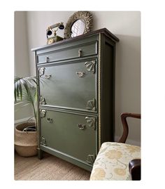 a green dresser sitting next to a window