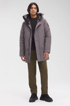 The Langford gets an update with streamlined hood adjustment, additional drop-in pockets, and added backpack straps. This stylish urban piece is similar to the Chateau parka but is slightly longer for greater leg protection. With a storm flap over the centre front zipper and two interior pockets, Langford offers clean lines and a modern look - all in an uncompromisingly protective parka. Customize your parka and extend the coverage of your hood with a variety of our interchangeable Hood Trim acc Canada Goose Mens Parka, Men Parka, The Chateau, Baby Outerwear, Long Parka, Mens Parka, Great Legs, Snow Pants, A Storm