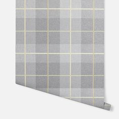 the grey and yellow plaid wallpaper is shown in an angled position with a white background