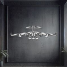 an airplane is shown in the middle of a room with dark walls and wood flooring