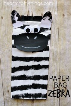 a zebra paper bag with googly eyes on it's face and the words paper bag zebra written in black