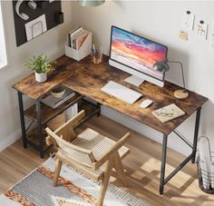 a wooden desk with a computer monitor and keyboard