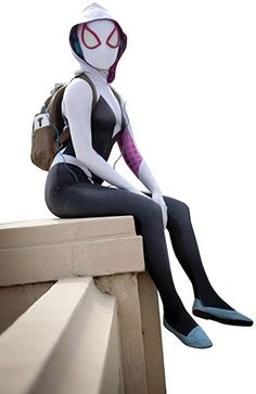 a woman dressed as spider - man sitting on a ledge