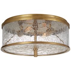 a semi flush light fixture with glass and gold accents on the bottom, hanging from an antique brass ceiling fixture