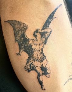 a man with a bat tattoo on his leg