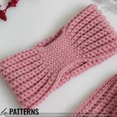 a knitted headband and mittens are laying next to each other