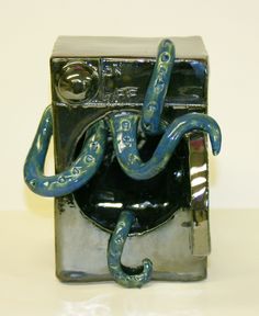 a metal box with a blue snake on it's side and a chain hanging from the front